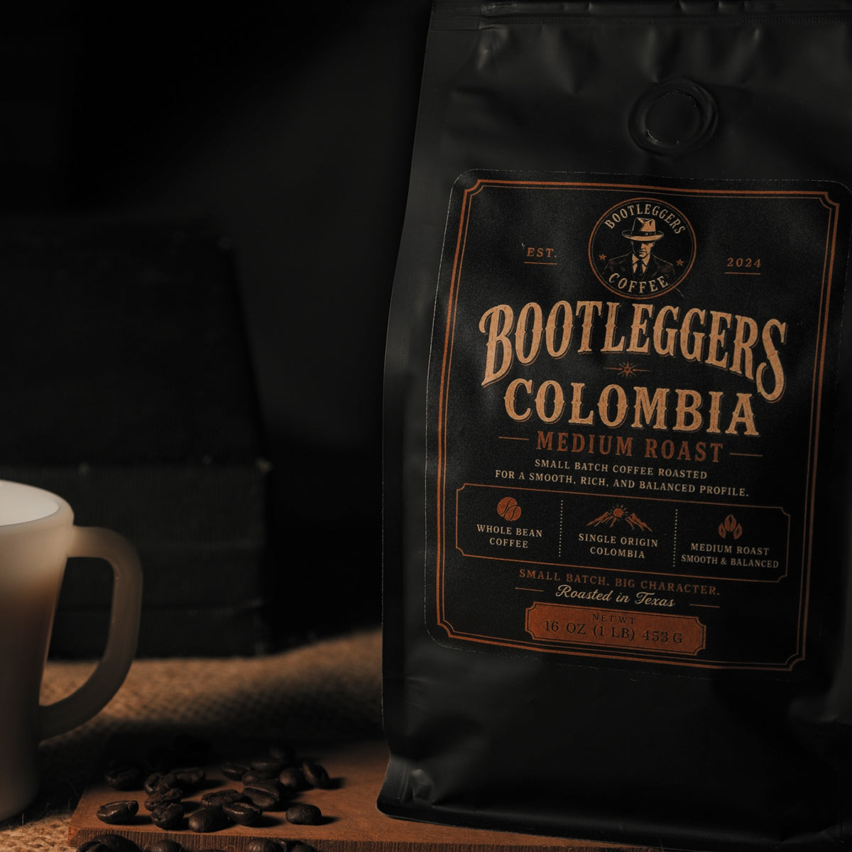Bootleggers Coffee Colombia Medium Roast 16 oz bag with coffee mug and roasted beans