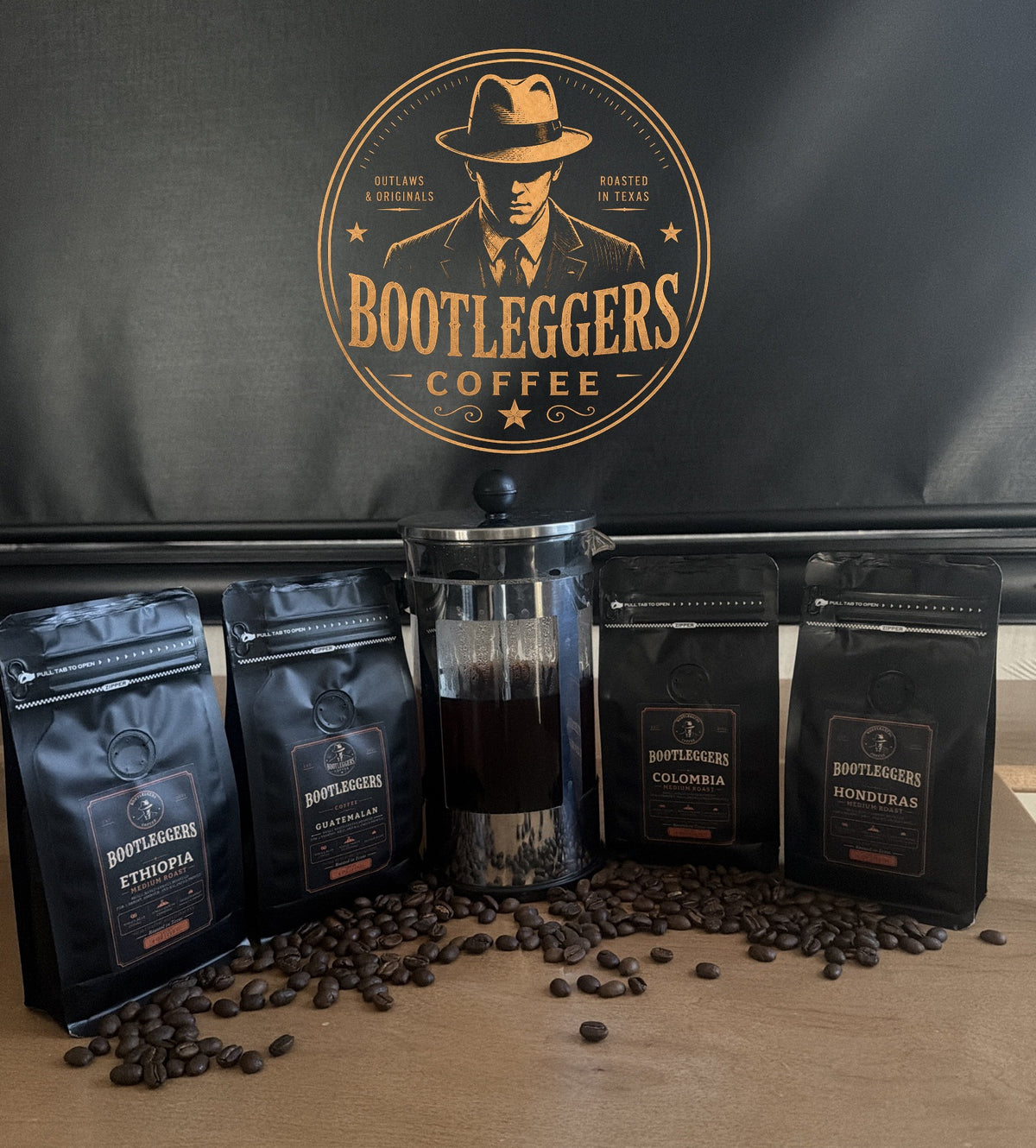 Bootleggers Coffee Medium Roast Flight with a French press of brewed coffee and coffee beans